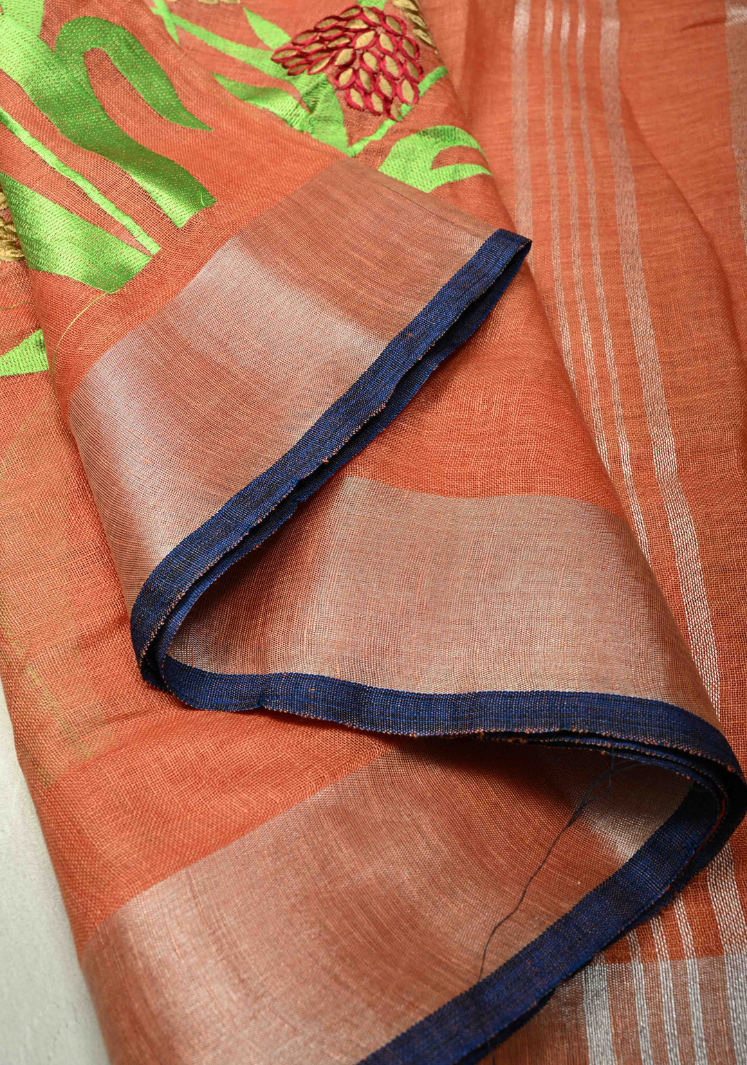 Dark Peach Linen Saree with Botanical Machine Embroidery and Tissue Zari Border