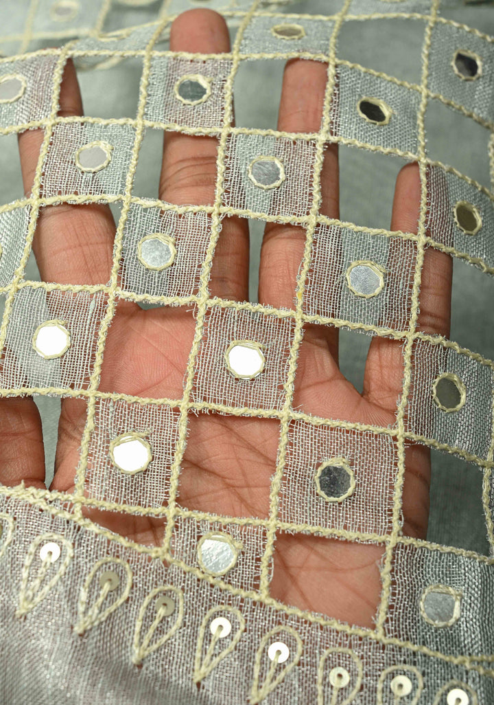 Cutwork and Mirror Work Tissue Linen Saree in Silver with Dramatic Fancy net Tassels