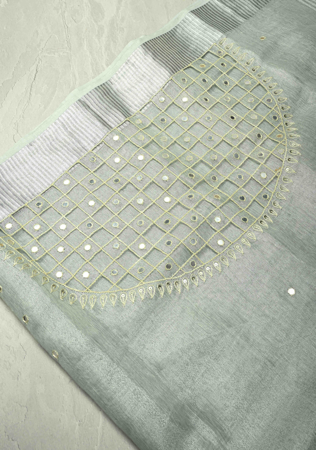 Cutwork and Mirror Work Tissue Linen Saree in Silver with Dramatic Fancy net Tassels