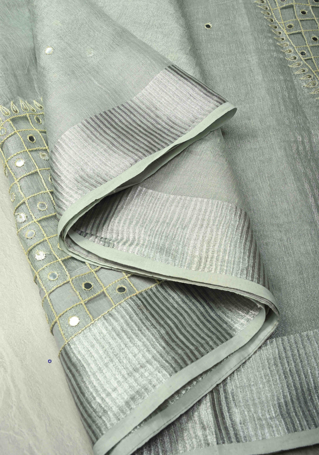 Cutwork and Mirror Work Tissue Linen Saree in Silver with Dramatic Fancy net Tassels