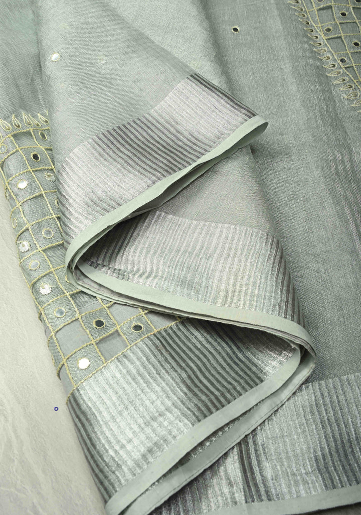 Cutwork and Mirror Work Tissue Linen Saree in Silver with Dramatic Fancy net Tassels