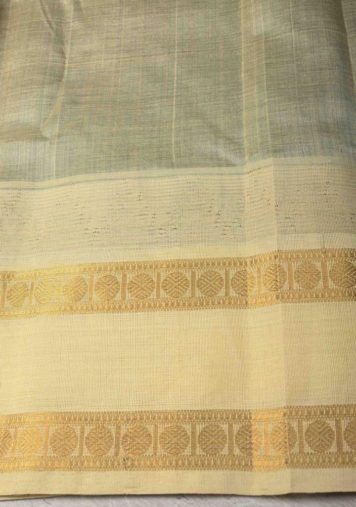 Bottle Green Zari Buttas on Kanchi Silk Cotton Saree with Zari Checks and Contrast Rettaipet Borders