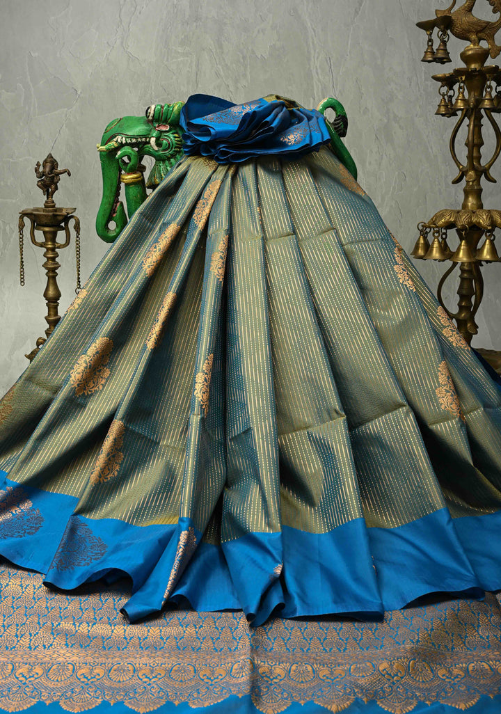 Sage Green-Blue Dual tone Vertical Zari Stripes on Kanchi Semi Silk Saree with Floral Buttas and Distinct Motifs on Contrast Border