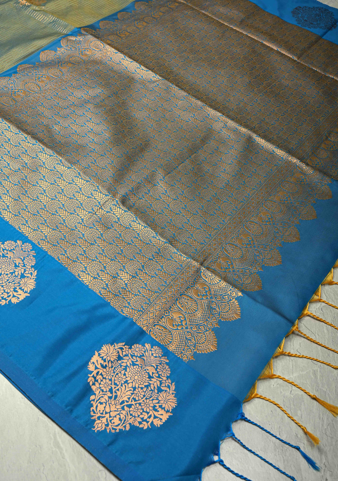 Sage Green-Blue Dual tone Vertical Zari Stripes on Kanchi Semi Silk Saree with Floral Buttas and Distinct Motifs on Contrast Border