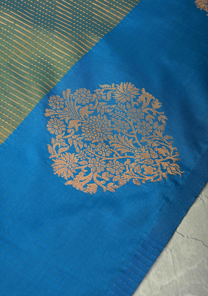 Sage Green-Blue Dual tone Vertical Zari Stripes on Kanchi Semi Silk Saree with Floral Buttas and Distinct Motifs on Contrast Border