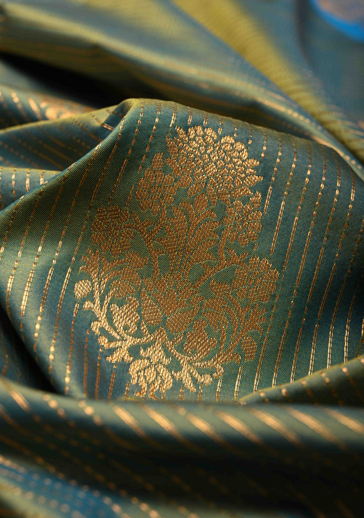 Sage Green-Blue Dual tone Vertical Zari Stripes on Kanchi Semi Silk Saree with Floral Buttas and Distinct Motifs on Contrast Border