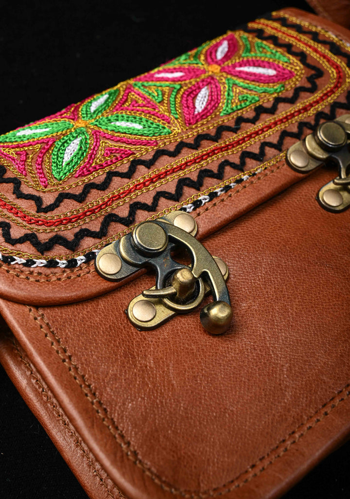 Brown Leather Double Buckle Sling Bag With Hand-Crafted And Floral Embroidery