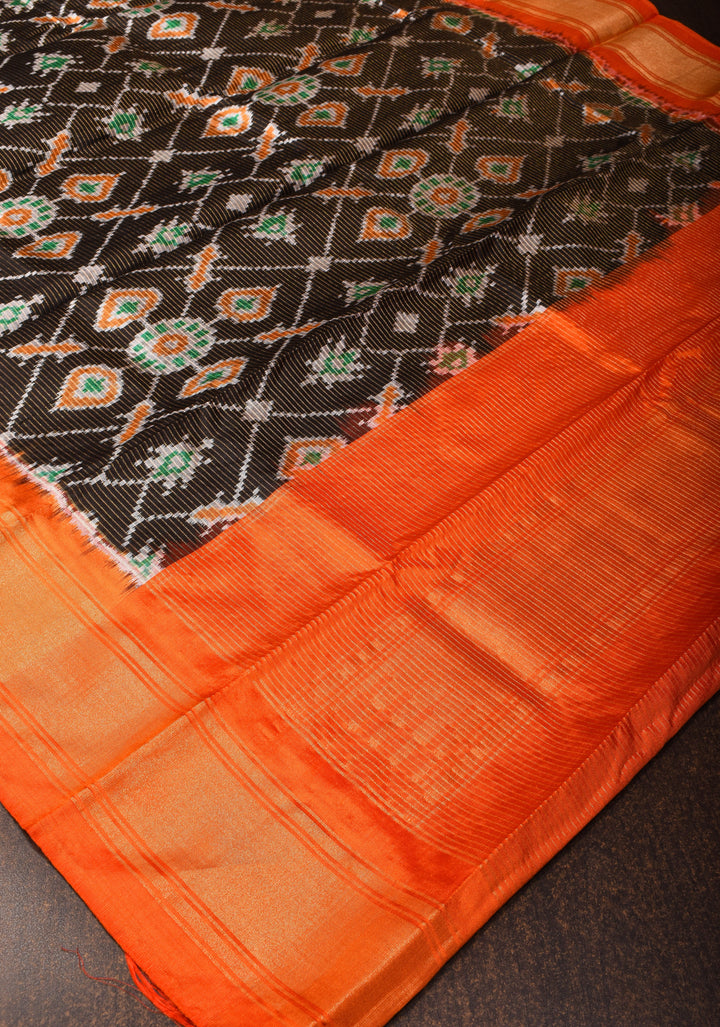 Dupatta : Black and Orange Ikkat Patola Design Pure Silk Dupatta with handmade tassels I SILK MARK CERTIFIED
