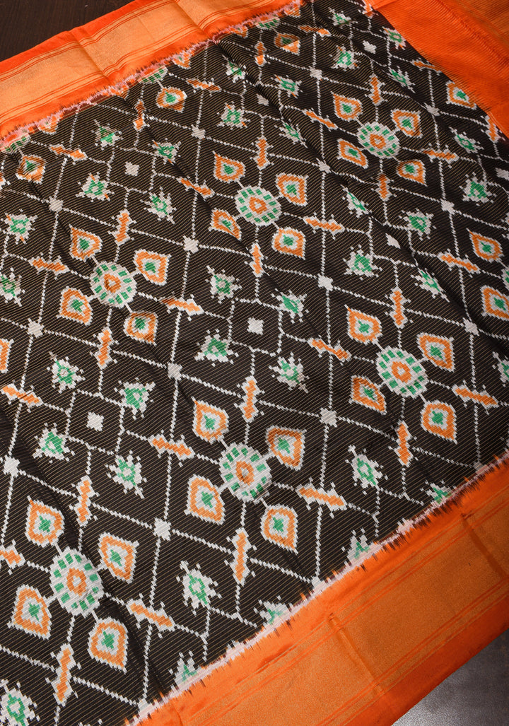 Dupatta : Black and Orange Ikkat Patola Design Pure Silk Dupatta with handmade tassels I SILK MARK CERTIFIED