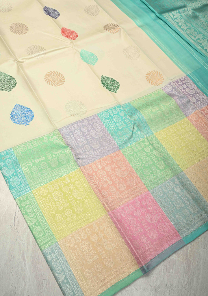 Ivory Handloom Pure Silk Kanchipattu Saree with Resham Meenakari Buttas and Pastel Hued Wide Zari Border | SILK MARK CERTIFIED