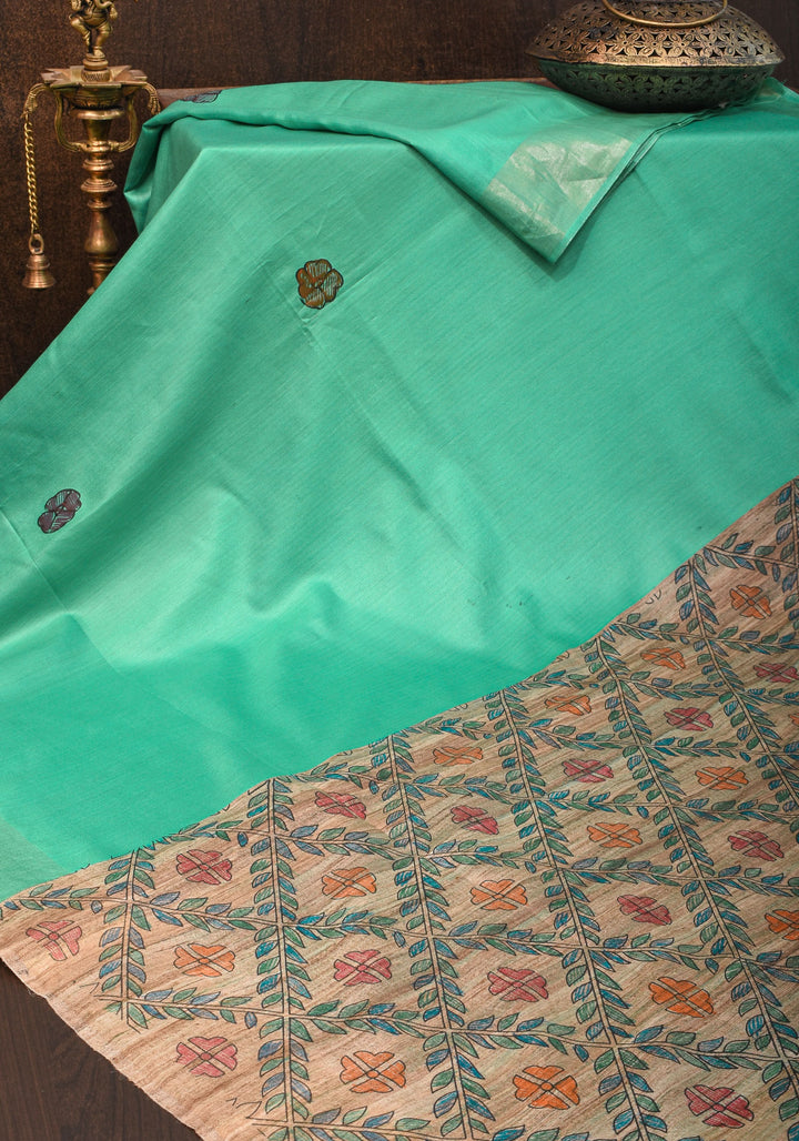 Sea Green Semi Tussar Silk, adorned with a Madhubani Hand painted Tussar Pallu and Zari Border