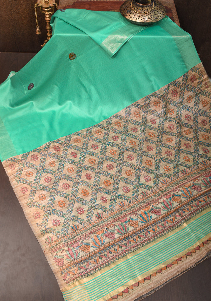 Sea Green Semi Tussar Silk, adorned with a Madhubani Hand painted Tussar Pallu and Zari Border