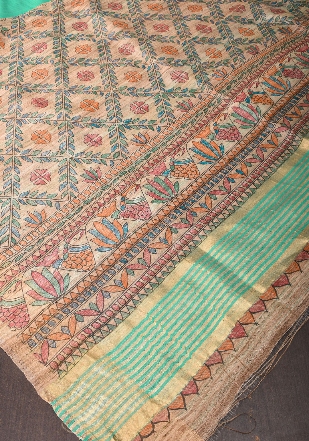 Sea Green Semi Tussar Silk, adorned with a Madhubani Hand painted Tussar Pallu and Zari Border