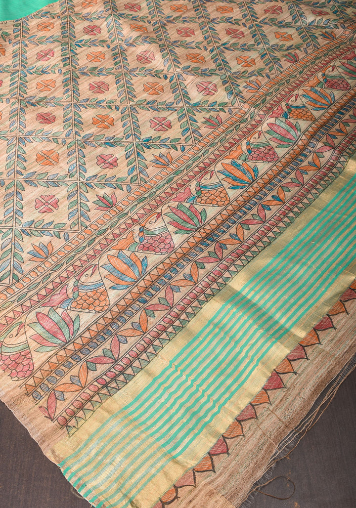 Sea Green Semi Tussar Silk, adorned with a Madhubani Hand painted Tussar Pallu and Zari Border
