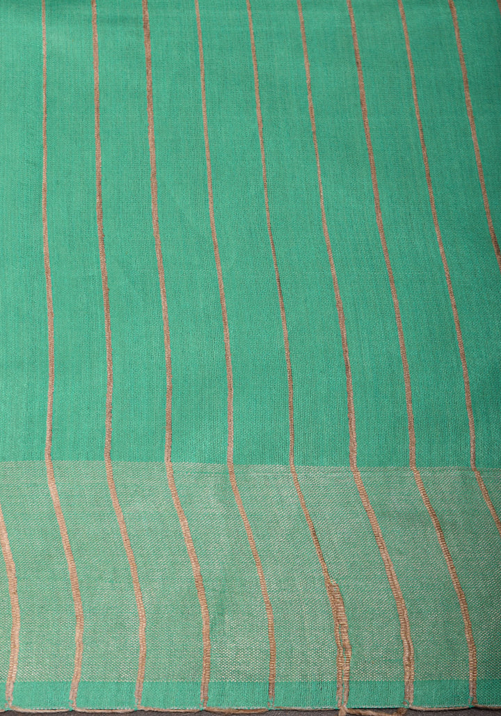 Sea Green Semi Tussar Silk, adorned with a Madhubani Hand painted Tussar Pallu and Zari Border