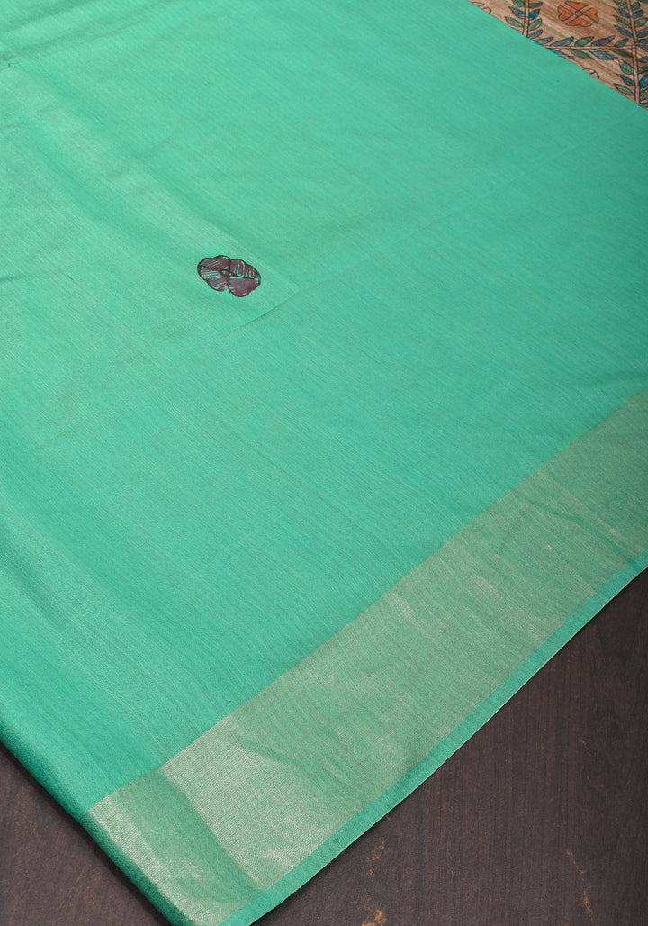 Sea Green Semi Tussar Silk, adorned with a Madhubani Hand painted Tussar Pallu and Zari Border