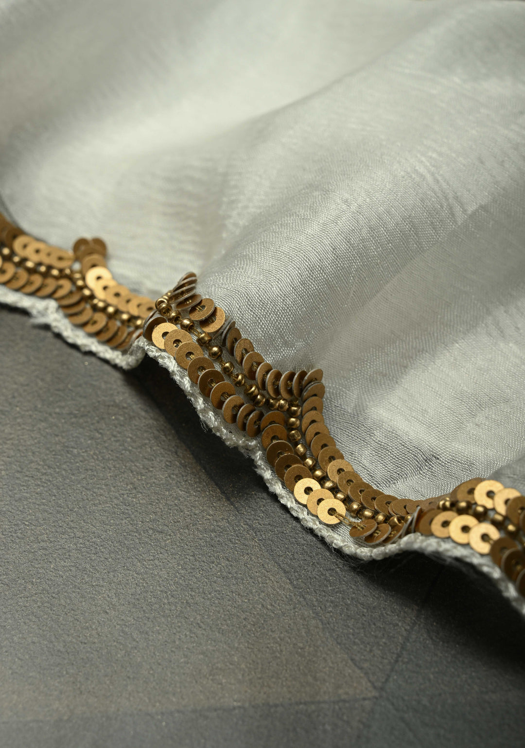 Ivory Satin Georgette Saree with Antique Matte Finish Cutdana, Sequins and Moti Embellishment and Scallop Border