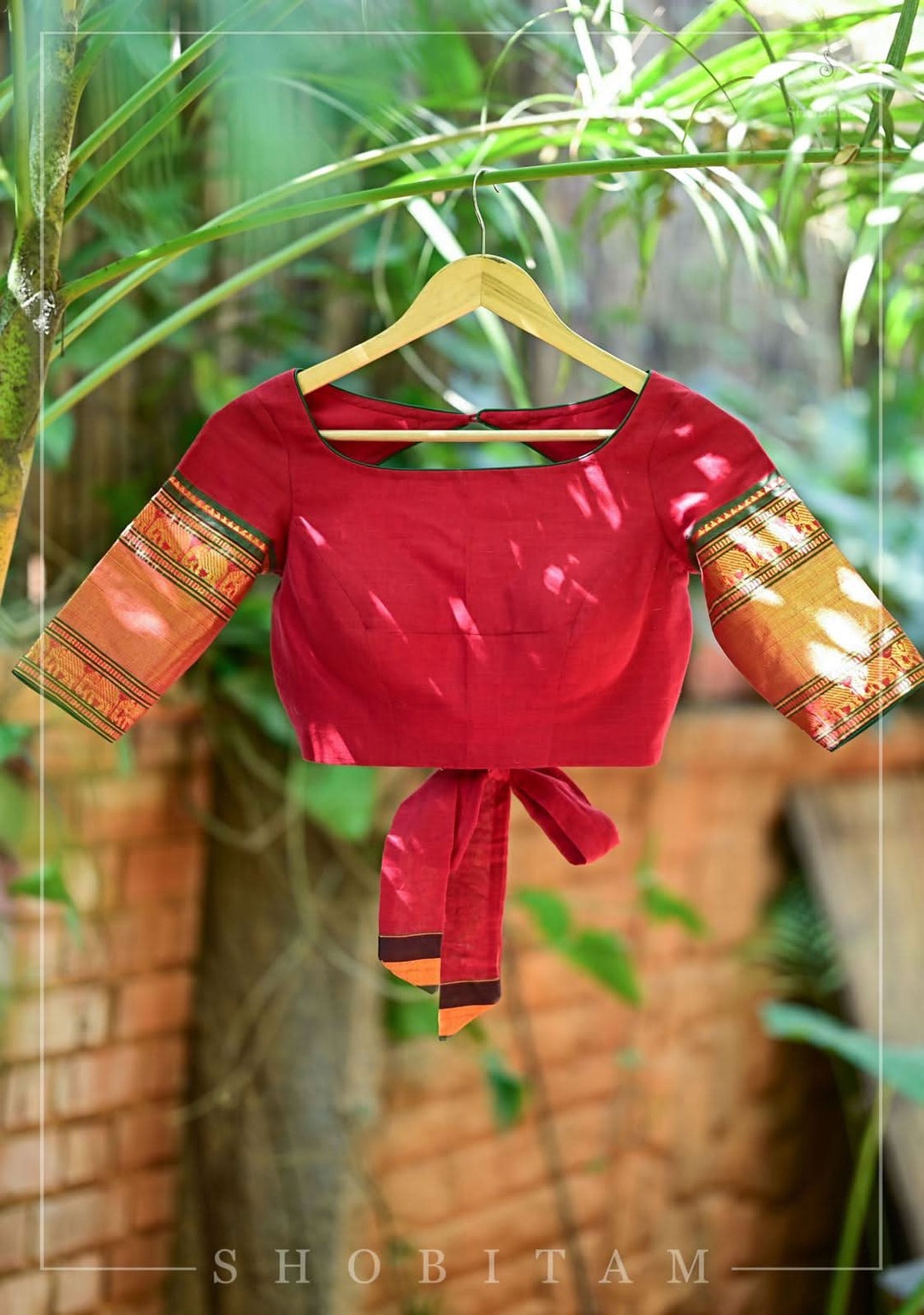 Maroon Narayanpet cotton boatneck blouse with oval cutout and tieback design
