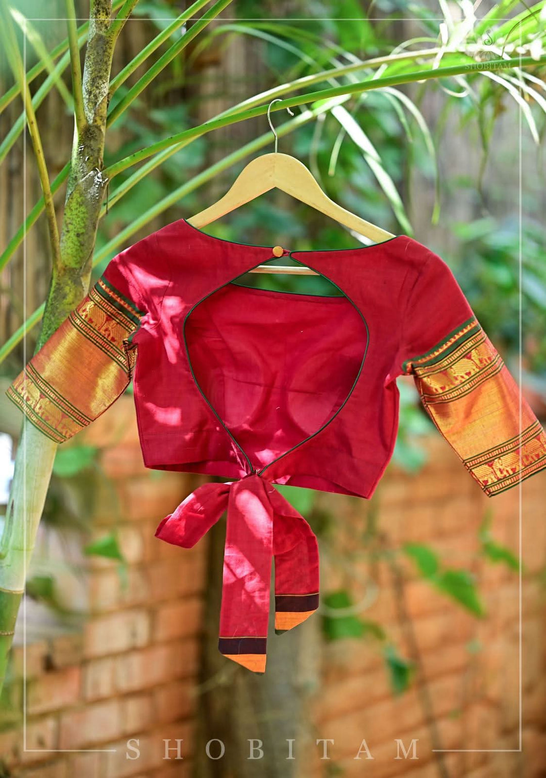 Maroon Narayanpet cotton boatneck blouse with oval cutout and tieback design