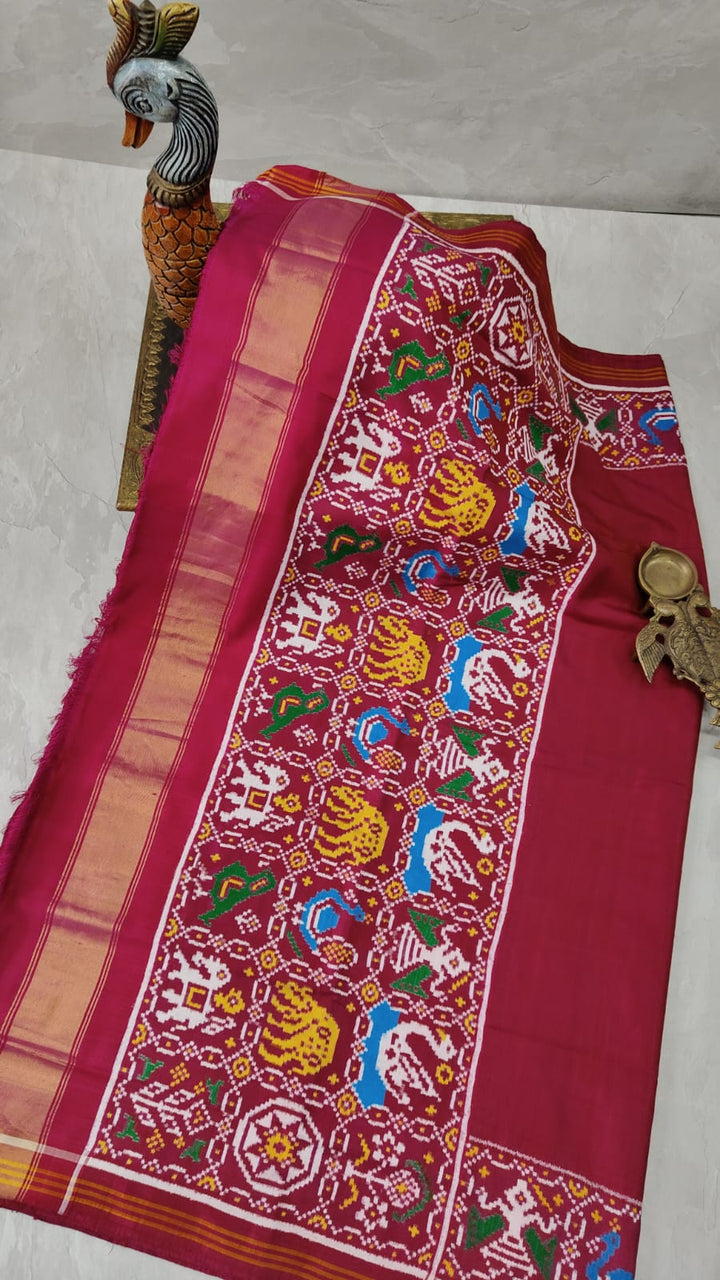 Celebrity Authentic Double Ikkat Patan Patola Handwoven Saree in Pinkish Red Dual tone with Flora Fauna Motifs on Border | SILK MARK CERTIFIED