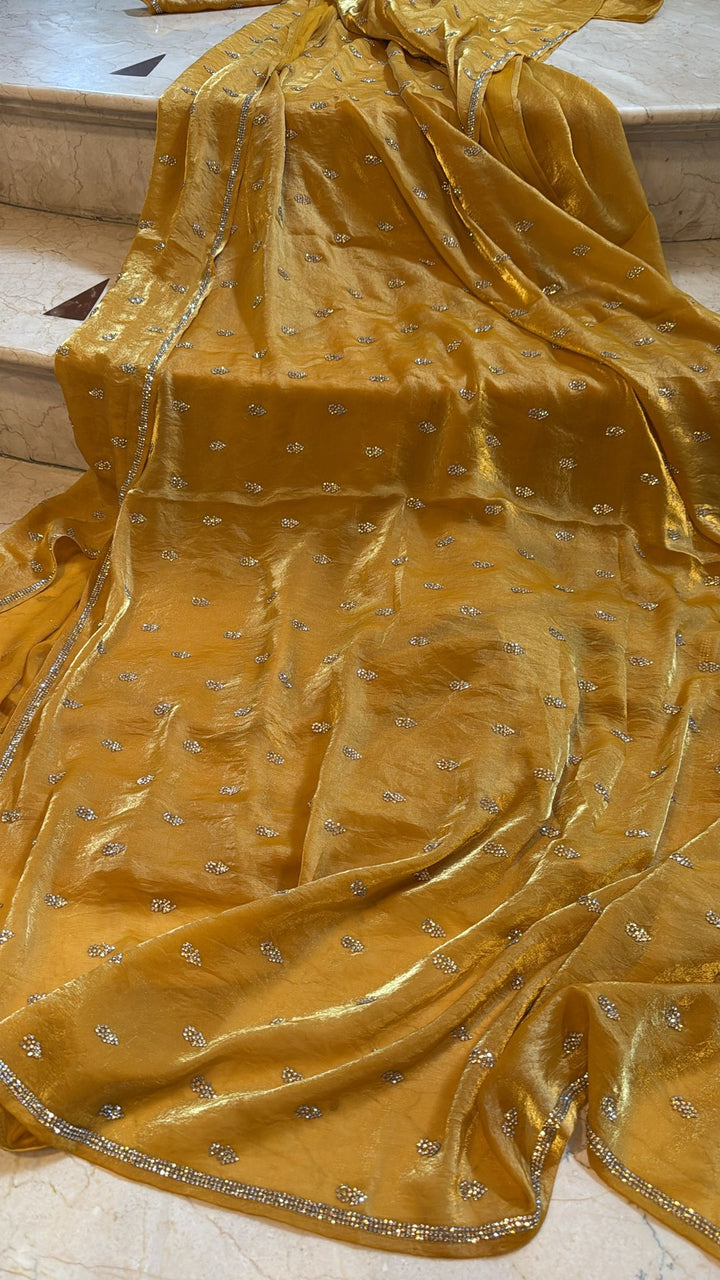 Ochre shimmer Georgette saree with stone buttas and minimal borders