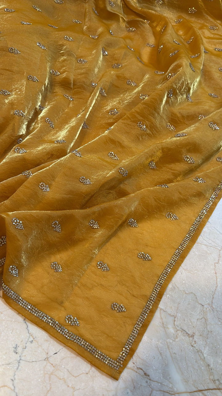 Ochre shimmer Georgette saree with stone buttas and minimal borders