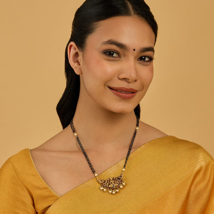 Traditional Gold-Plated Mangalsutra with Lakshmi Pendant and Pearl Embellishments