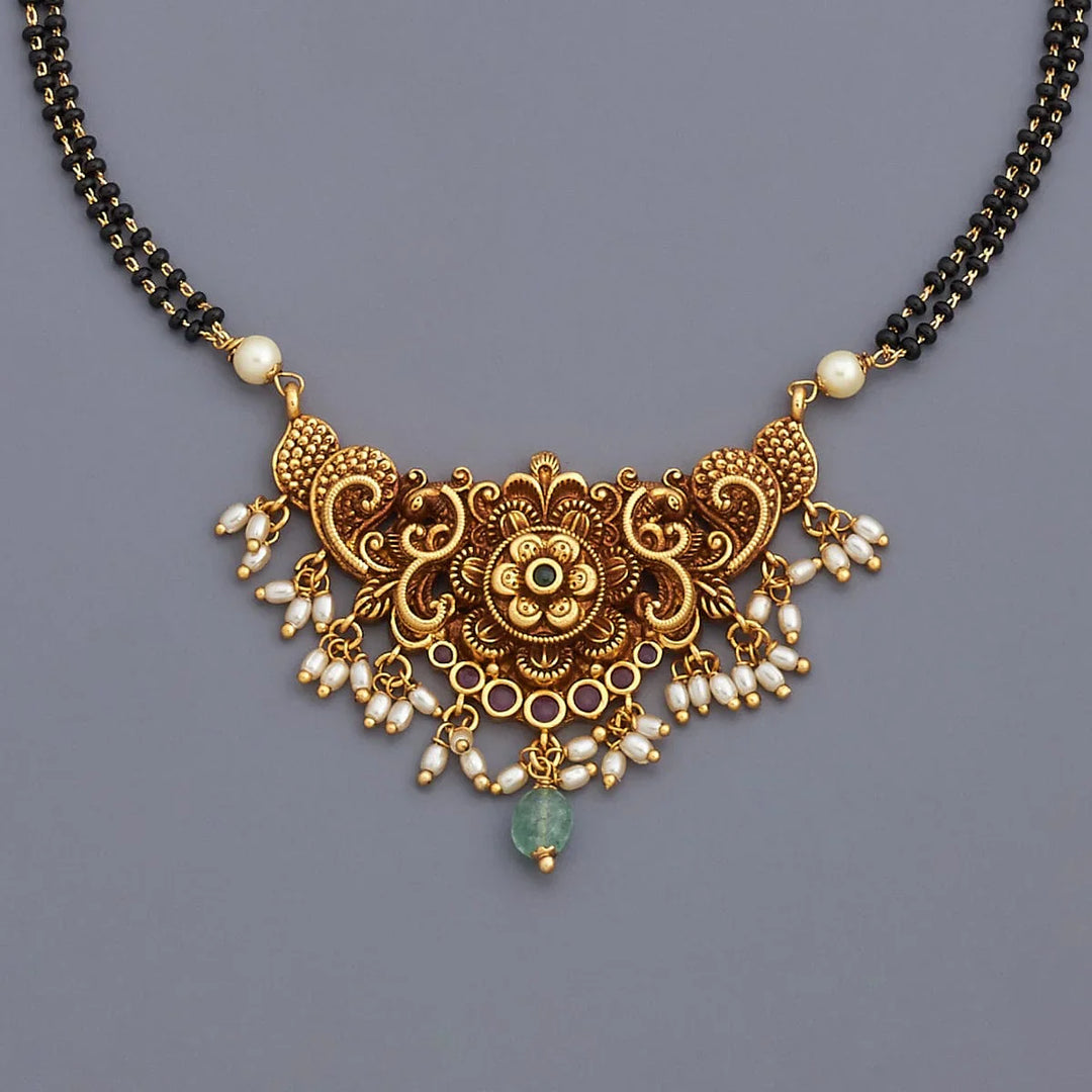 Traditional Gold-Tone Black Bead Mangalsutra with Intricate Flower Design and Pearl, Green Stone Accents
