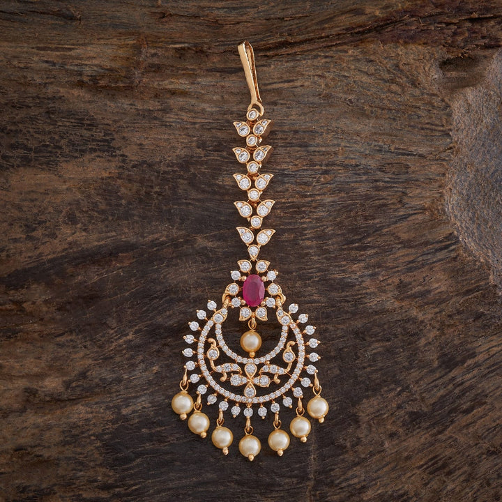 Flower Motif Handcrafted gold-polished Tikka embellished with synthetic stones and beads in Ruby