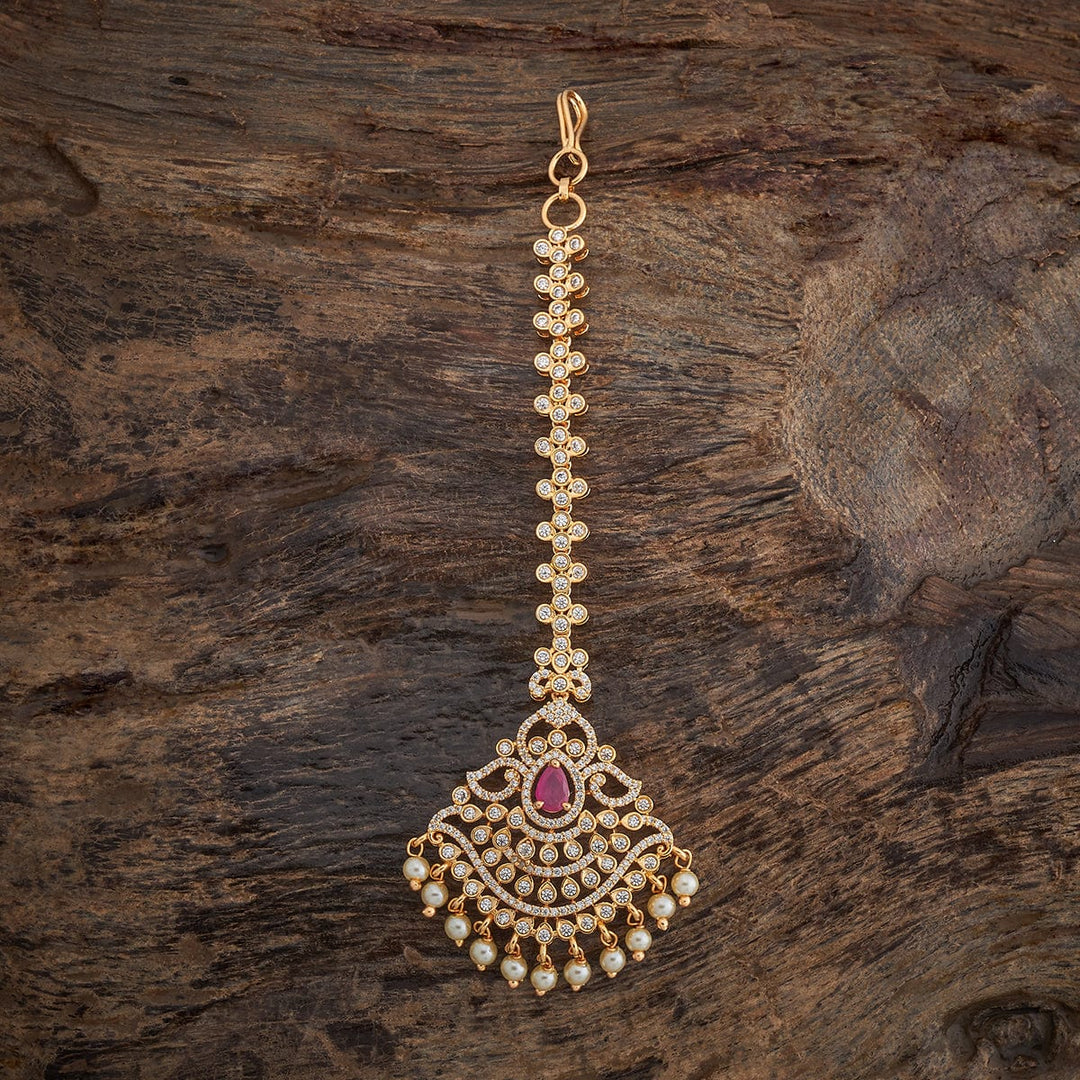 Traditional Design Tikka with shimmering White Ruby stones and beads finished in luxurious gold polish