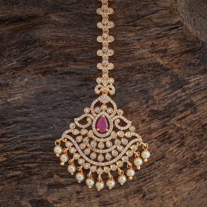 Traditional Design Tikka with shimmering White Ruby stones and beads finished in luxurious gold polish